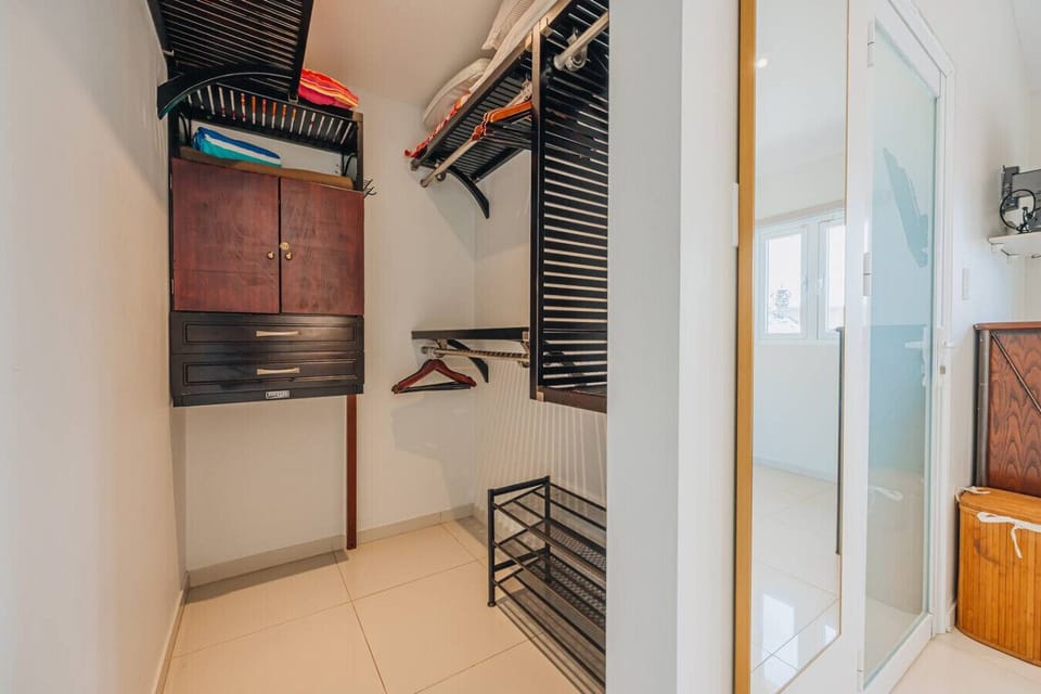 Efficiently designed, this spacious closet combines style and organization, offering ample storage solutions for your essentials.