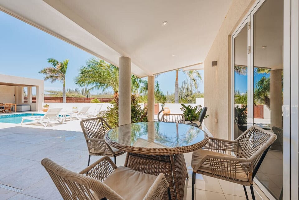 Gather around the stylish table for four where you can enjoy meals and conversations while soaking in the beautiful poolside views.