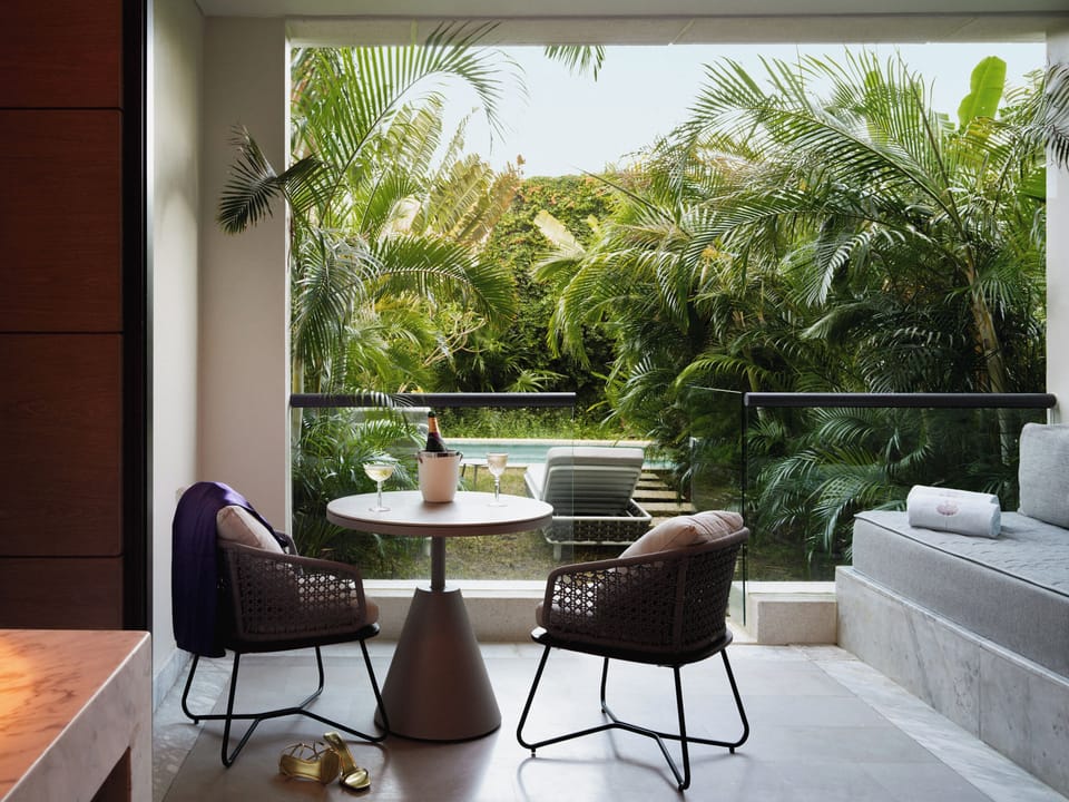 Toast the evening on your private terrace surrounded by palms.