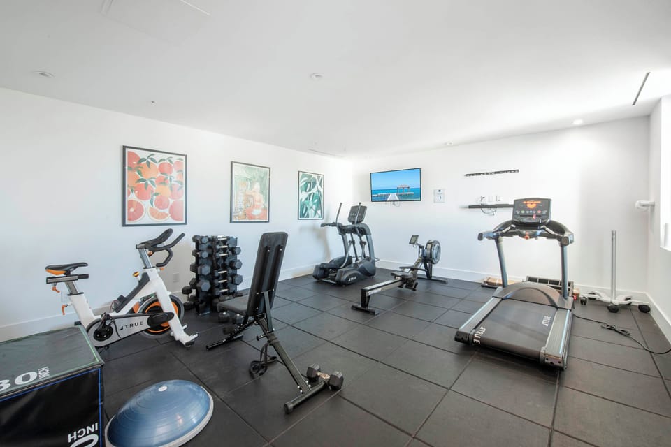 The resort's gym with weights and cardio equipment.