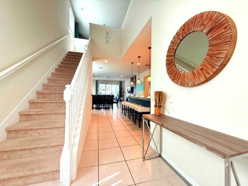 Elegant staircase to the upper level—access themed bedrooms and upstairs loft.