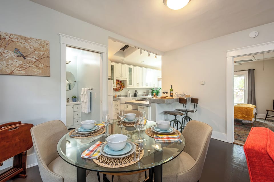 Dining area w/ round glass table (seats 4) + kitchen bar (seats 2)