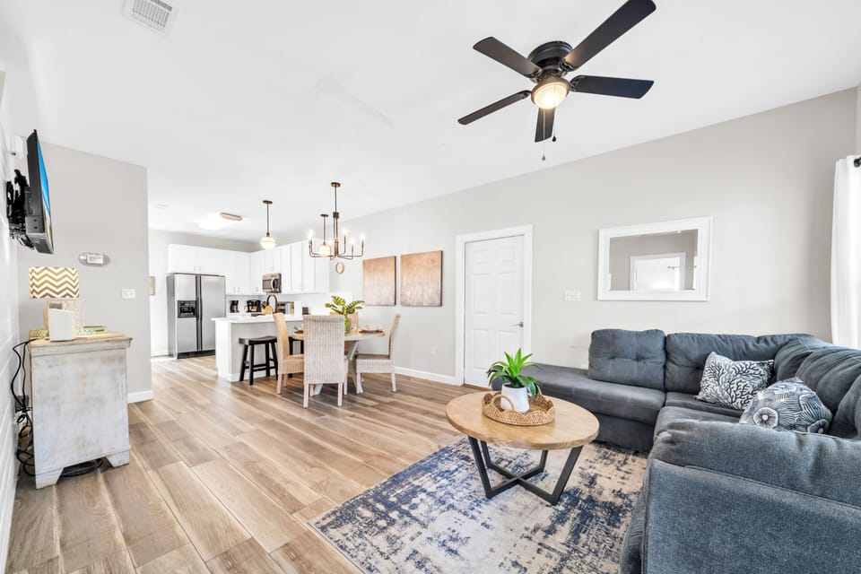 Relax in your spacious open-concept living area with stylish furnishings, modern kitchen, and comfortable seating for memorable evenings.