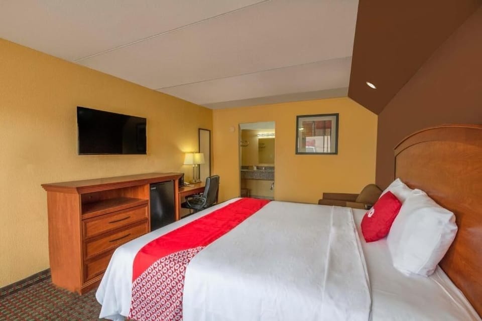 Unwind on crisp linens with TV and workspace nearby.