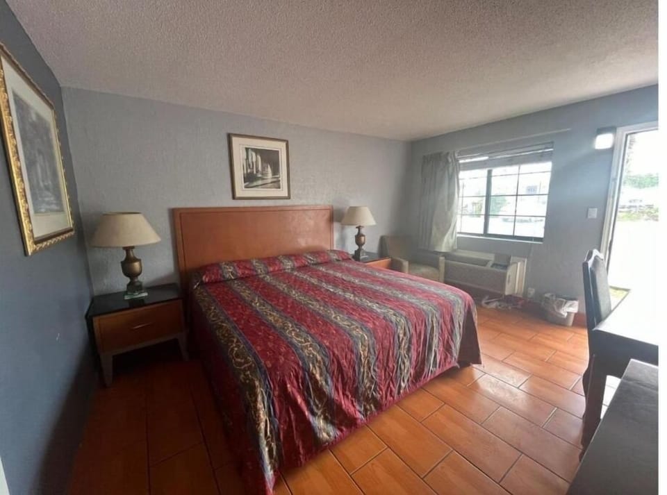 Unwind in a sunlit bedroom with a spacious, cozy bed.
