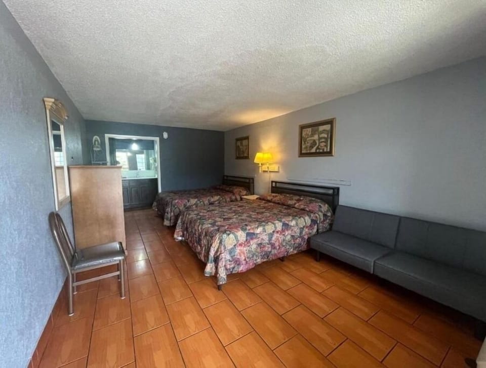 Relax in a spacious room with beds and lounging area.