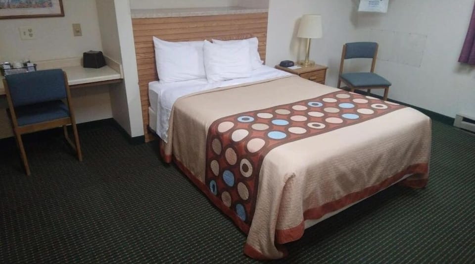 Unwind on crisp linens in a simple, restful room.