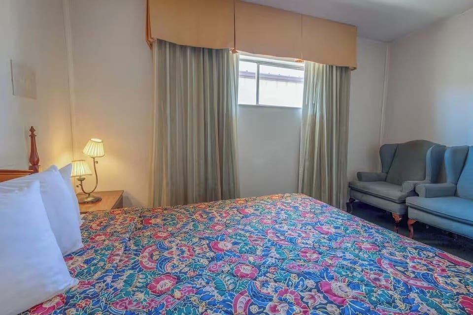 Relax on plush seating beside your bed and soft curtains.
