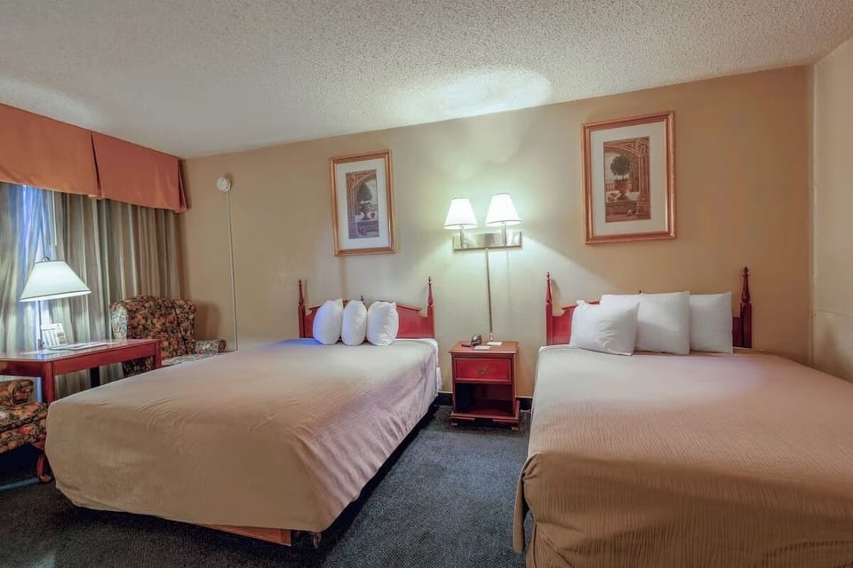 Drift off in crisp linens with bedside lighting glow.