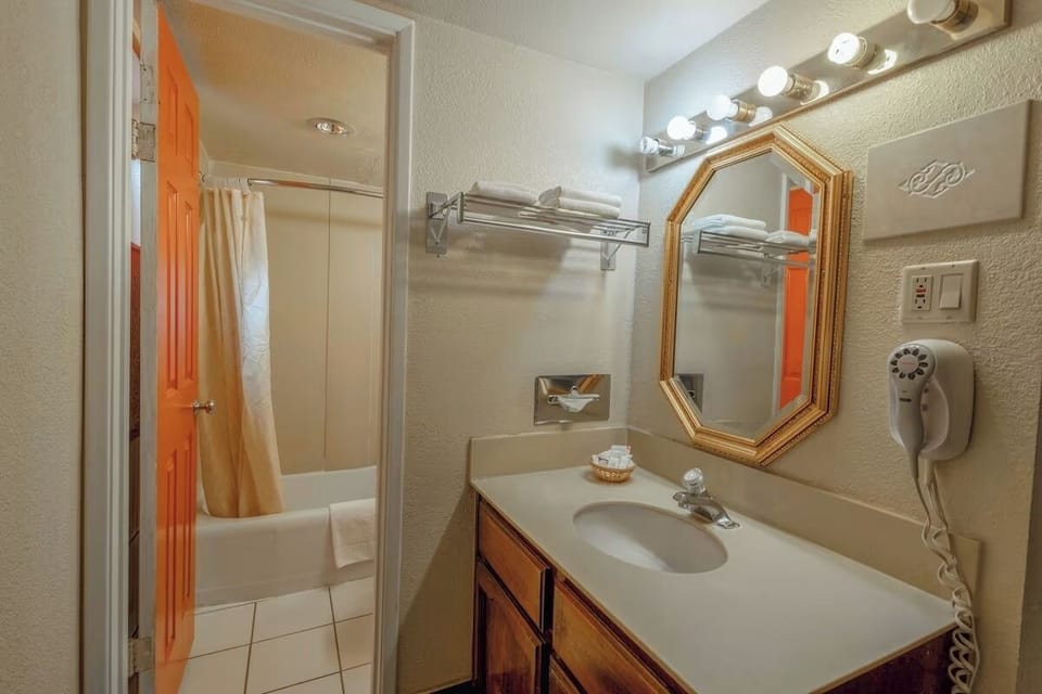 Step into a tidy bath space with fresh towels ready.