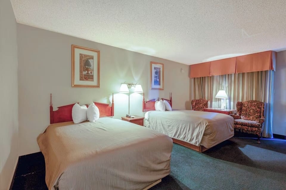 Wake up to soft daylight beside cozy seating by the window.
