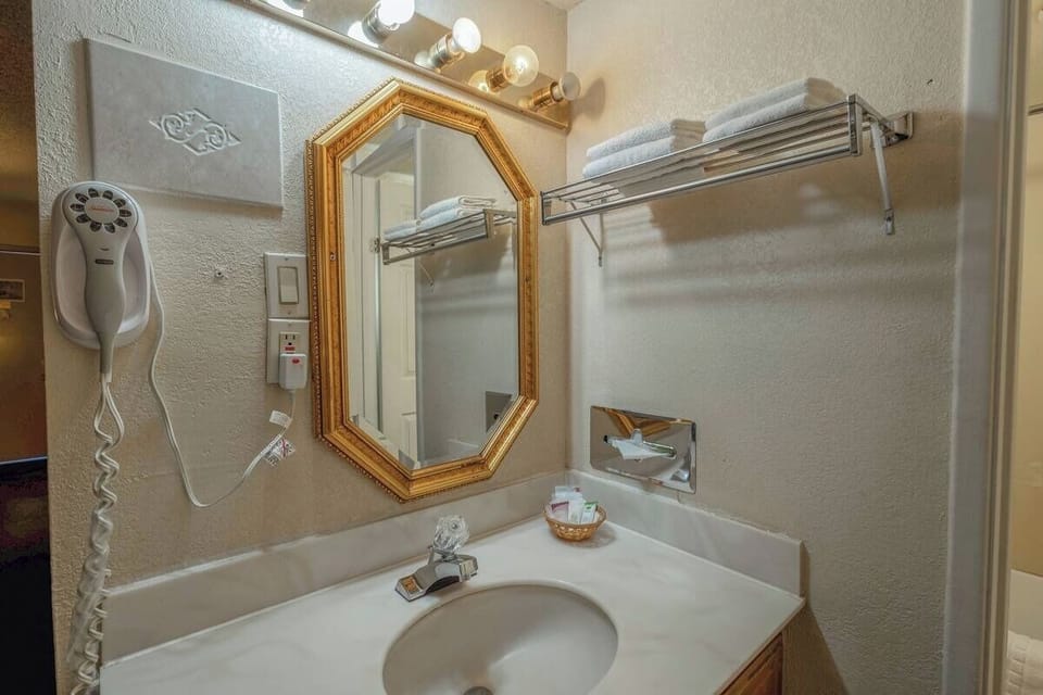 Freshen up easily at the bright vanity with stocked towel shelves.