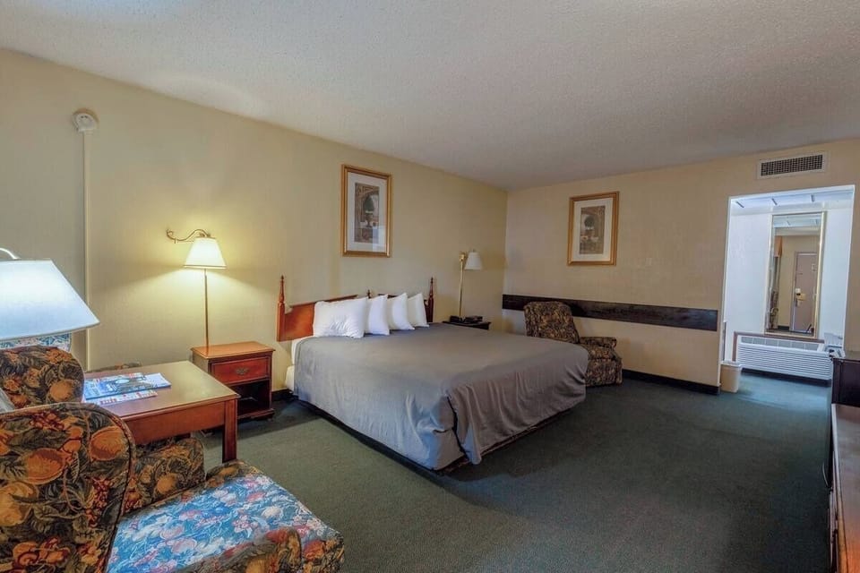 Stretch out comfortably in a roomy layout with warm bedside lighting.