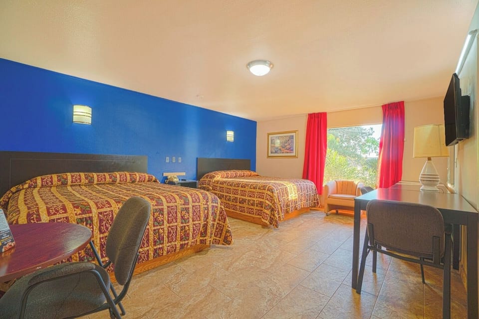 Stretch out with two beds, a desk, and sunny window views.