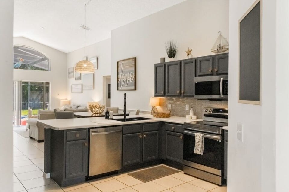 Full kitchen with breakfast bar, fridge freezer, oven, hob, microwave, dishwasher and coffee bar. 