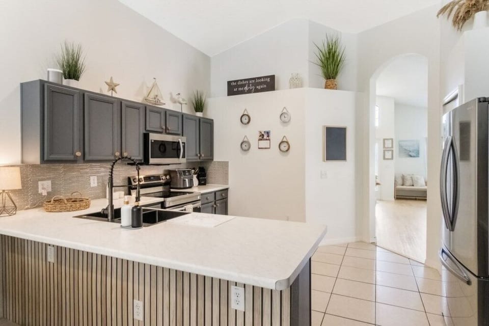 Full kitchen with breakfast bar, fridge freezer, oven, hob, microwave, dishwasher and coffee bar. 