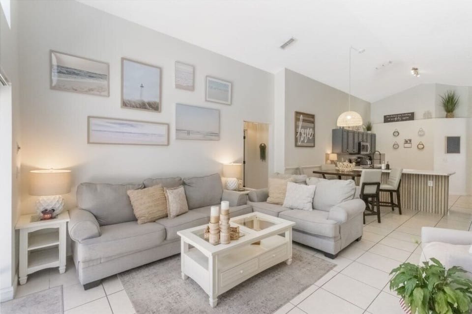 Living room with patio door access to pool deck and pool, also with smart tv. 