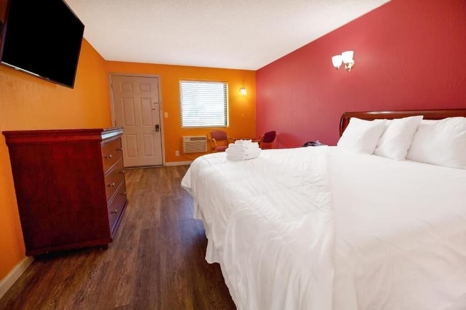 Unwind on a crisp king bed in a bright room.