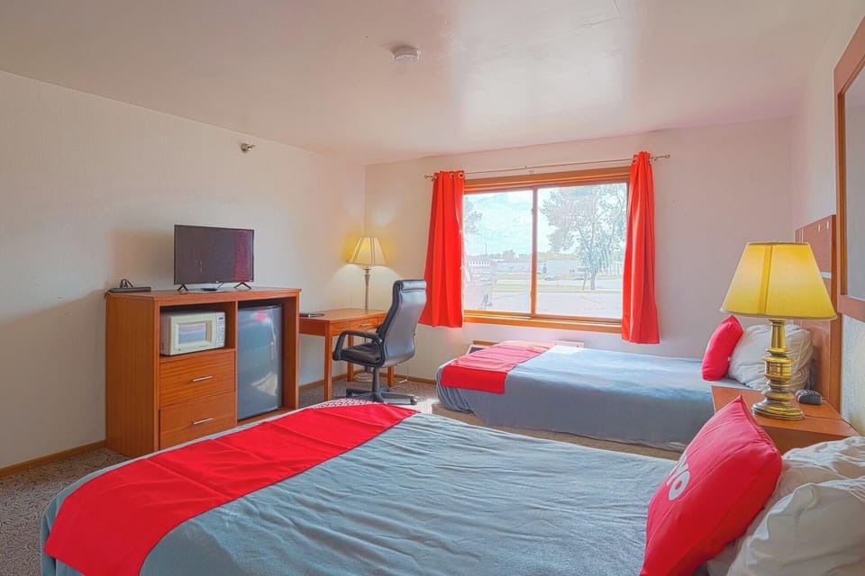 Settle in comfortably with two beds, desk, and TV.