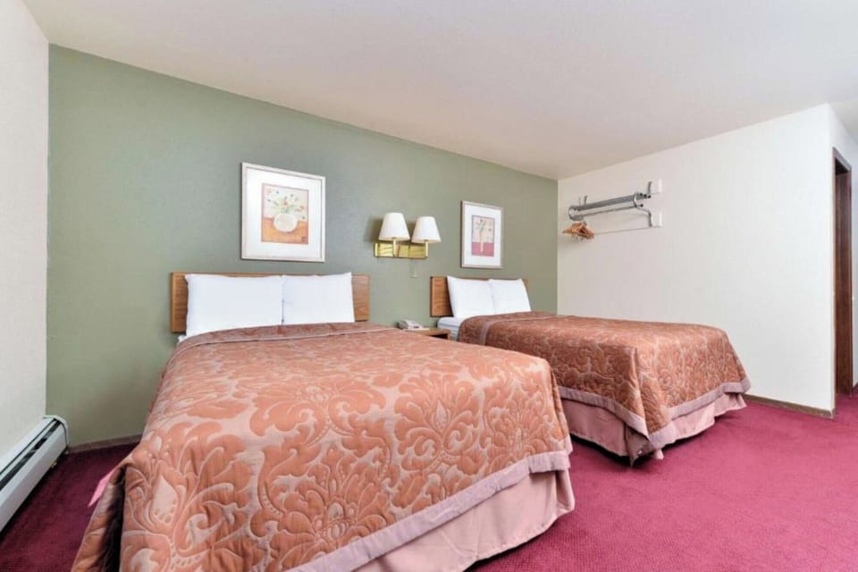 Relax in a spacious double-bed room with warm lighting.