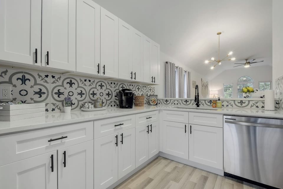 Spacious white kitchen with designer tile and premium finishes