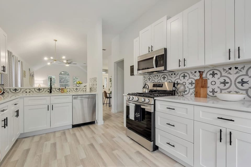 Modern chef’s kitchen with stainless appliances and custom backsplash