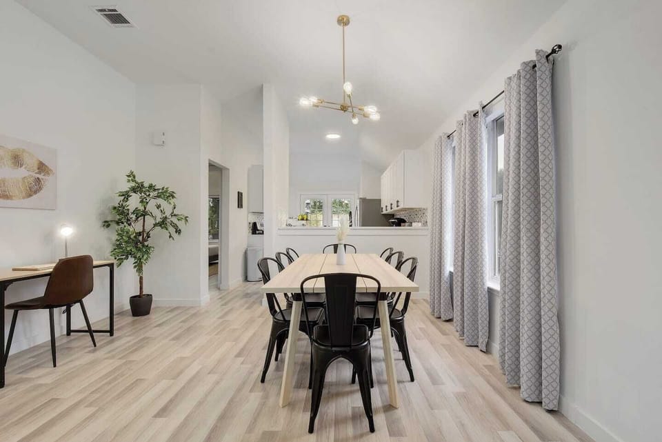 Open dining area with modern lighting and airy layout