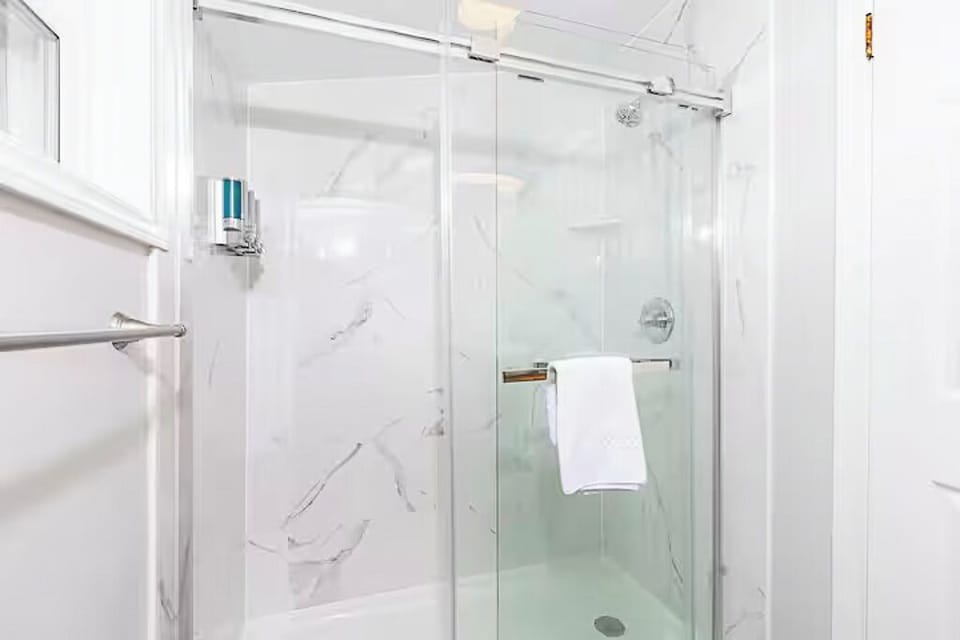 Loft bathroom - complete with full walk-in shower, sink and toilet