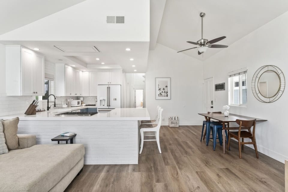 Gourmet kitchen with island seating and dining area for casual meals or hosting.