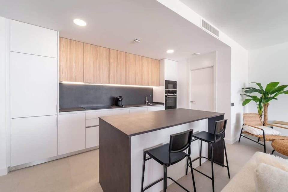 Fully equipped kitchen with modern appliances and cookware