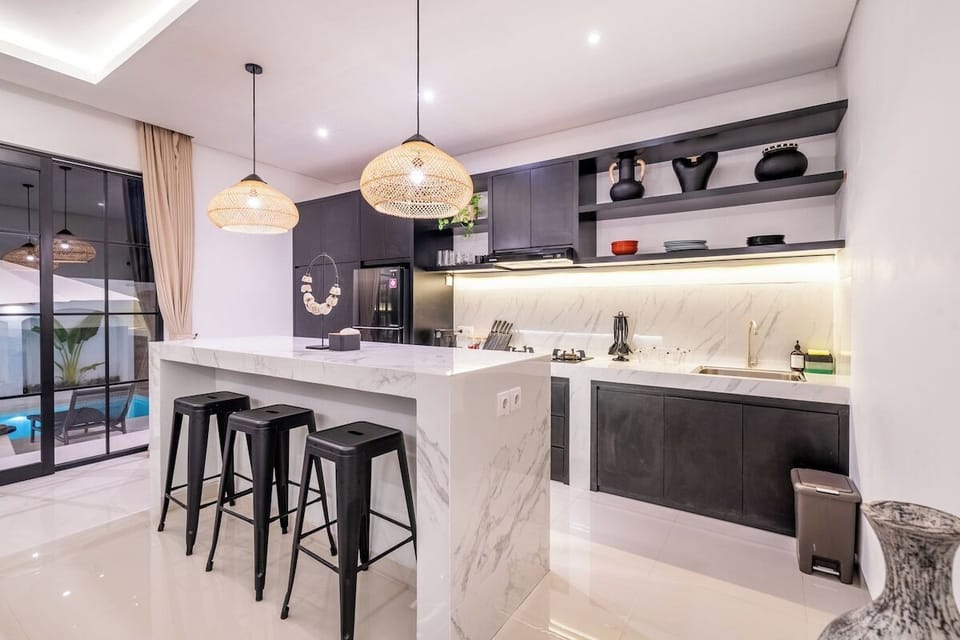 Sunlit and spacious, this Mediterranean-style kitchen blends charm and functionality with elegant finishes and open access to outdoor dining. #Villa Bratan