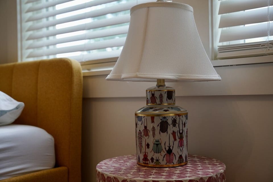 Playful design details like this beetle print lamp make every bedroom at Parkway House Goshen feel one of a kind. Thoughtful touches throughout each room add character and charm, giving guests something new and delightful to discover.