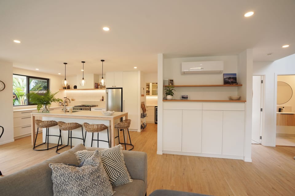 open kitchen into the dining area, the outdoor BBQ are and pool