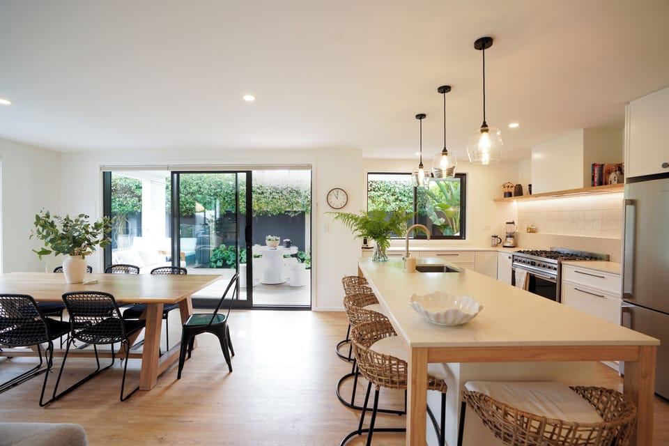 open kitchen into the dining area, the outdoor BBQ are and pool