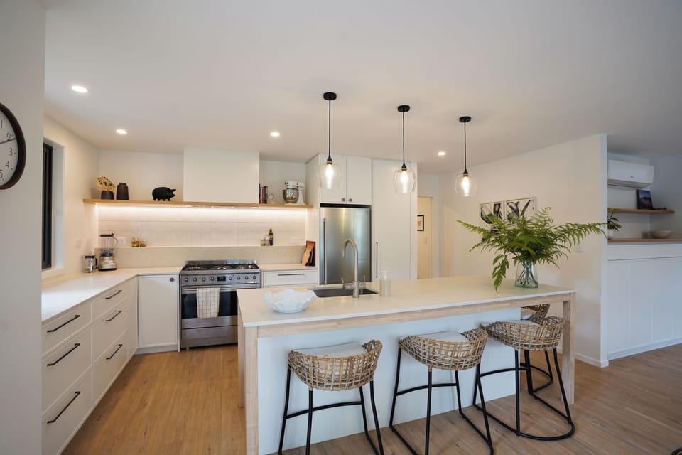 open kitchen into the dining area, the outdoor BBQ are and pool