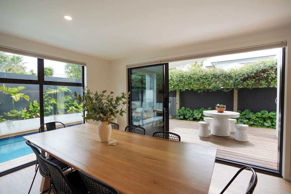 open kitchen into the dining area, the outdoor BBQ are and pool