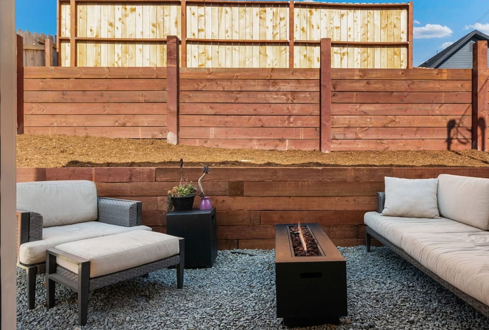 Private patio with comfy seating and fire pit for relaxing outdoors.