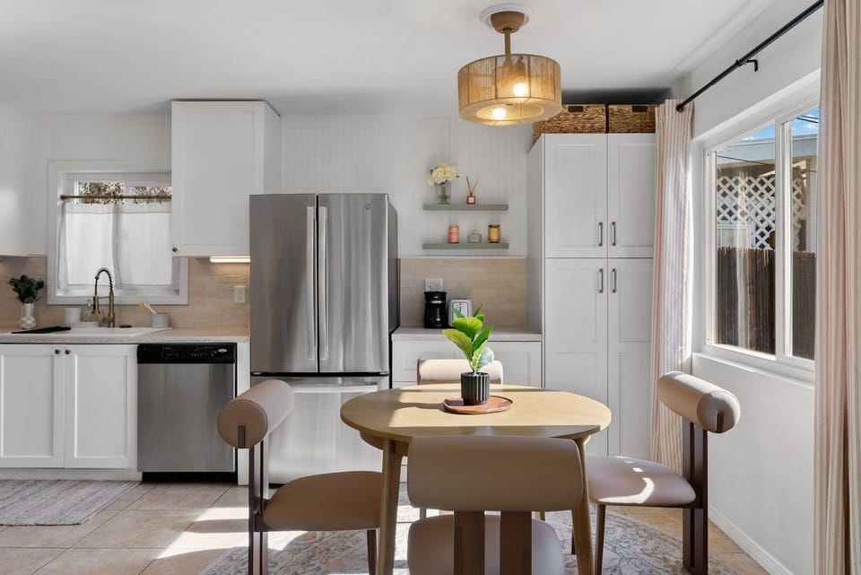 Bright kitchen with stainless appliances and a cozy dining table