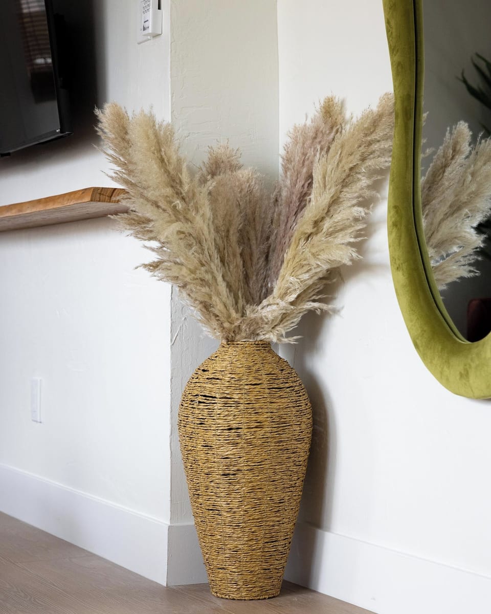 Woven vase with pampas grass adds a natural, modern touch to the living space. 