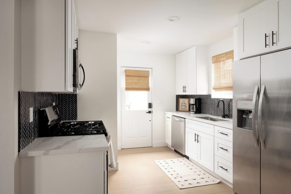 Fully equipped modern kitchen with stainless steel appliances and sleek finishes