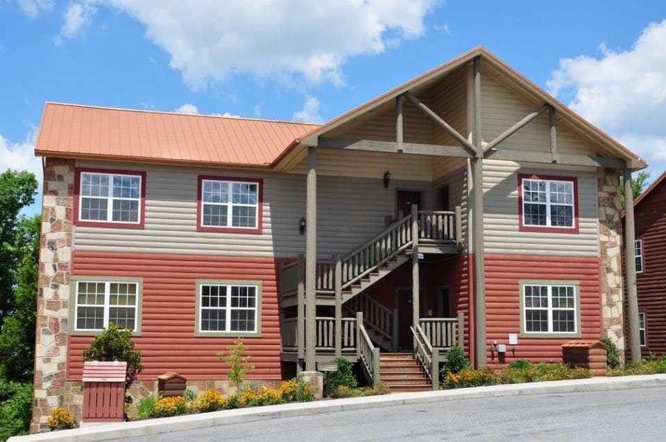 Front view of the resort with stairs and covered entryway.