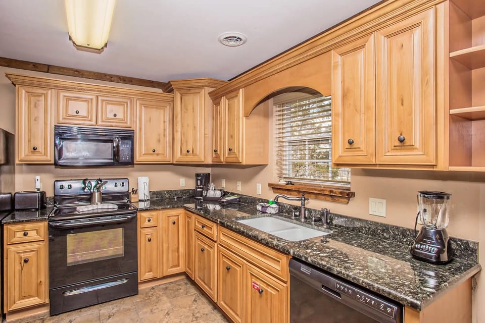 Kitchen with full-size appliances, granite counters, and ample storage.