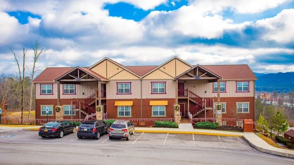 Exterior view of the resort's buildings with parking spaces in front.