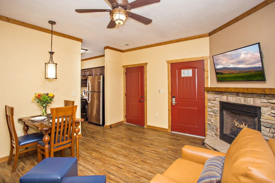 Living room with fireplace, flat-screen TV, and comfortable seating.