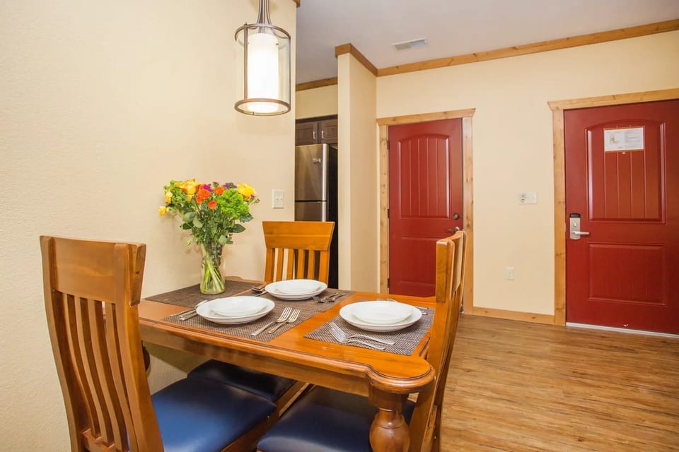 Dining area for four with warm wood accents and natural light.