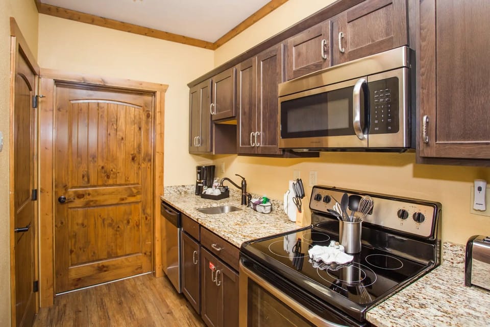 Kitchen with stainless steel appliances and wood cabinetry.