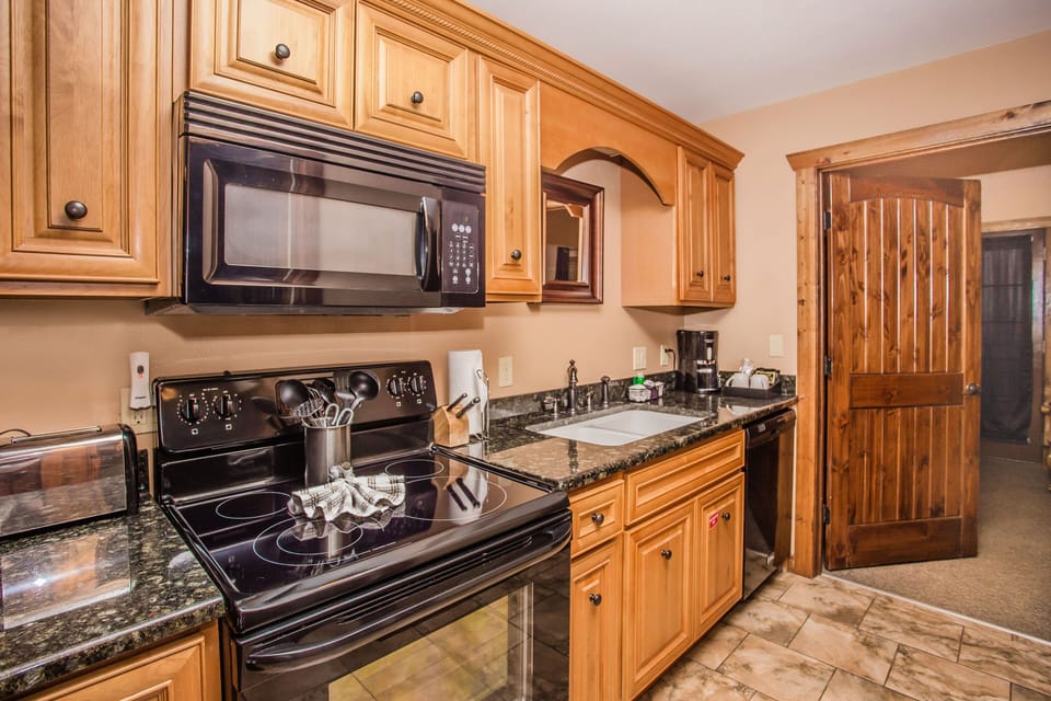 Kitchen with full-size oven, microwave, and ample counter space.