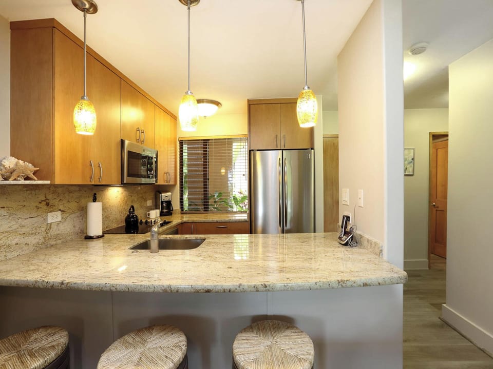 Upgraded with modern countertops, cabinetry, and a clean-canvas layout complete with essentials to prepare fresh meals.