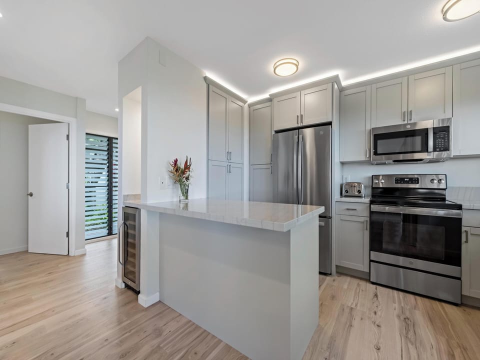 Appliances: Features an oven, microwave, dishwasher, refrigerator and even wine-fridge..