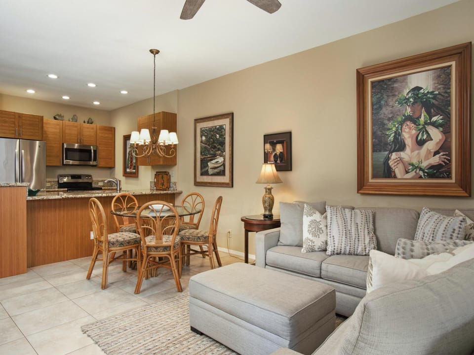 Step into your open-concept haven where the kitchen flows into a cozy living and dining area. Sink into plush seating after a day exploring, or gather around the tropical-style table for meals and laughter.